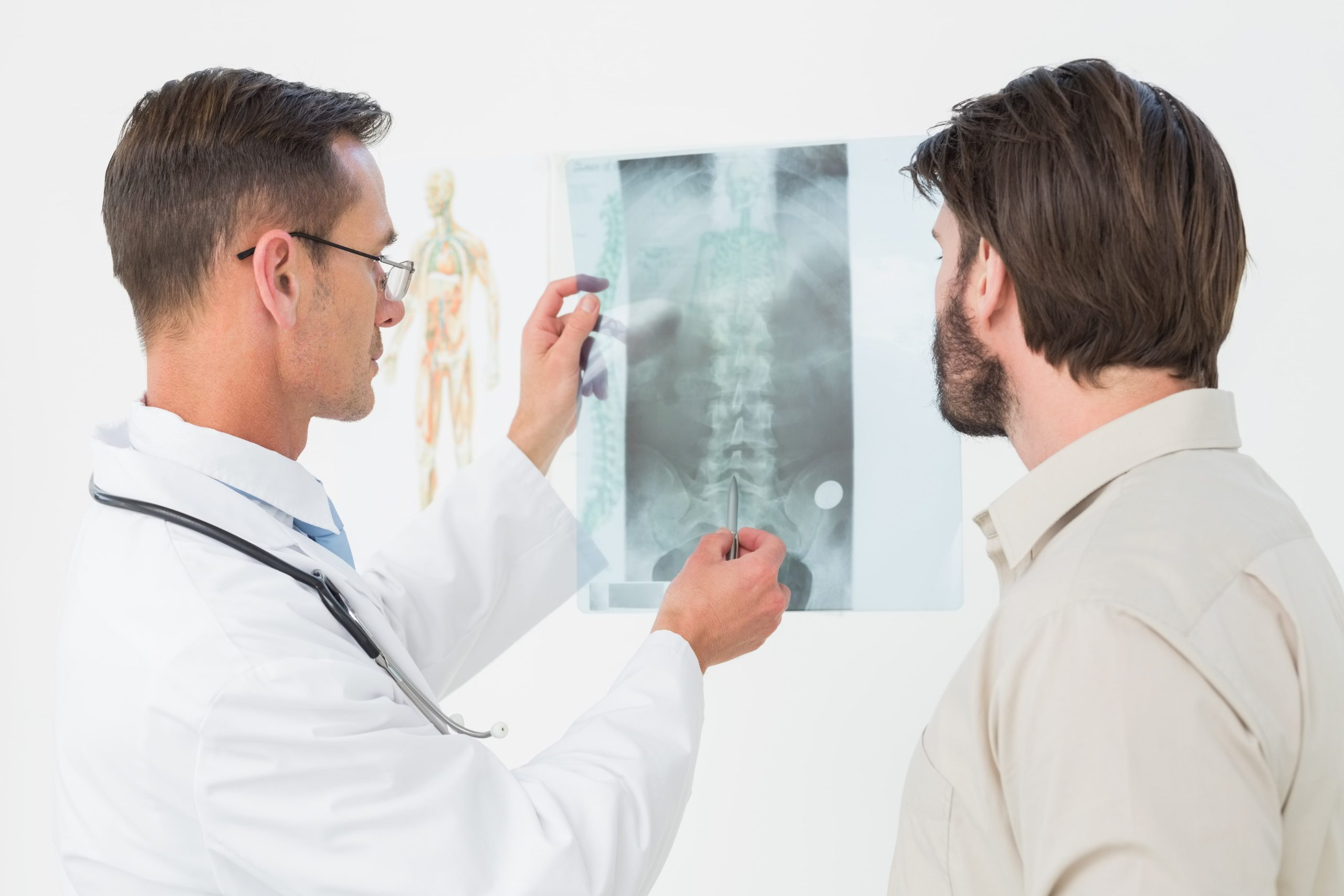 Male Doctor Explaining Spine Xray Patient Min Scaled